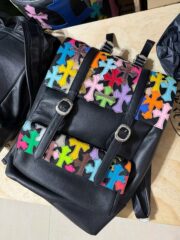 Colored leather and black leather backpacks